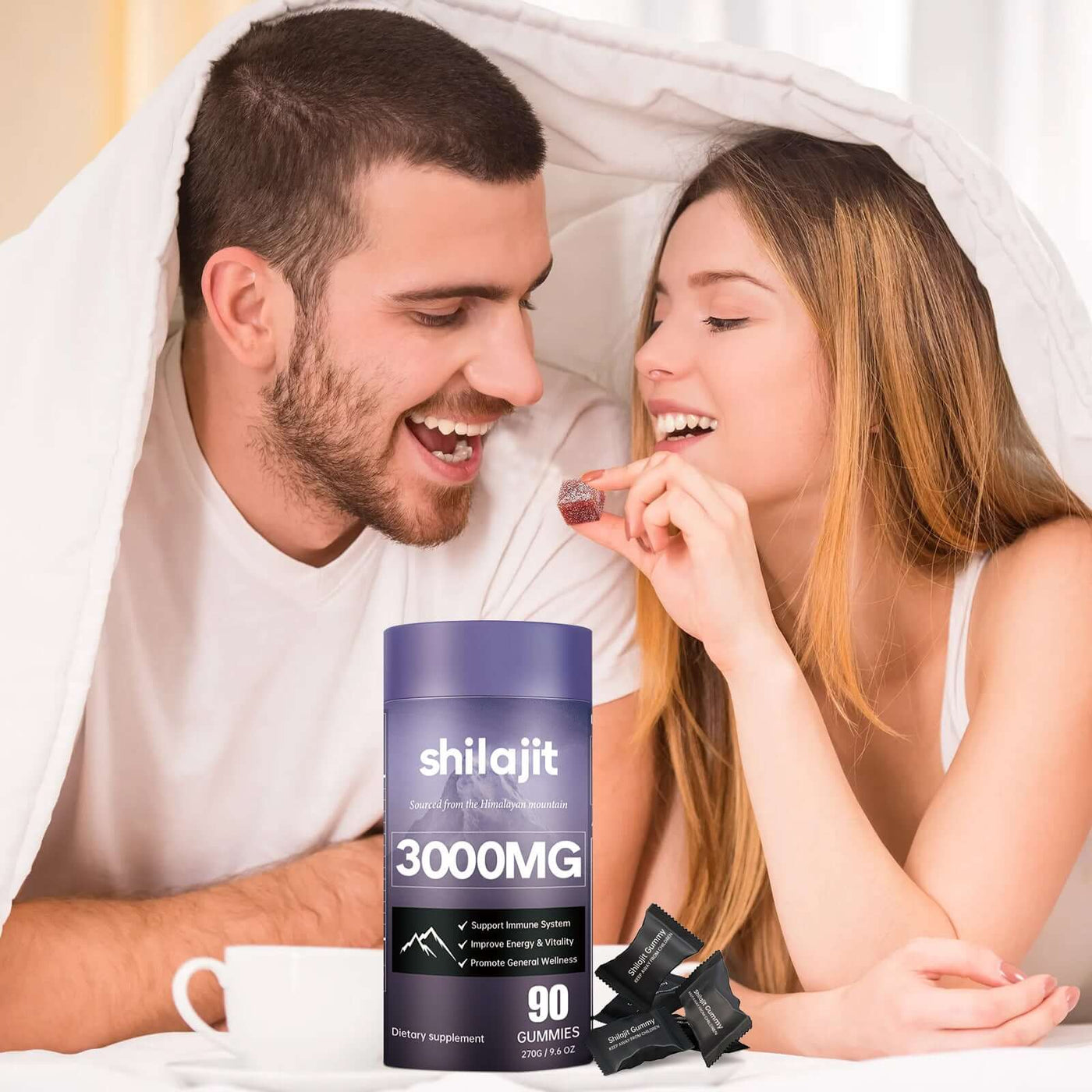 Couple enjoying Soft Candy Improves Resistance And Supplements Energy in bed with shilajit gummies.
